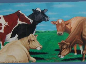 A mural of 5 different color cows