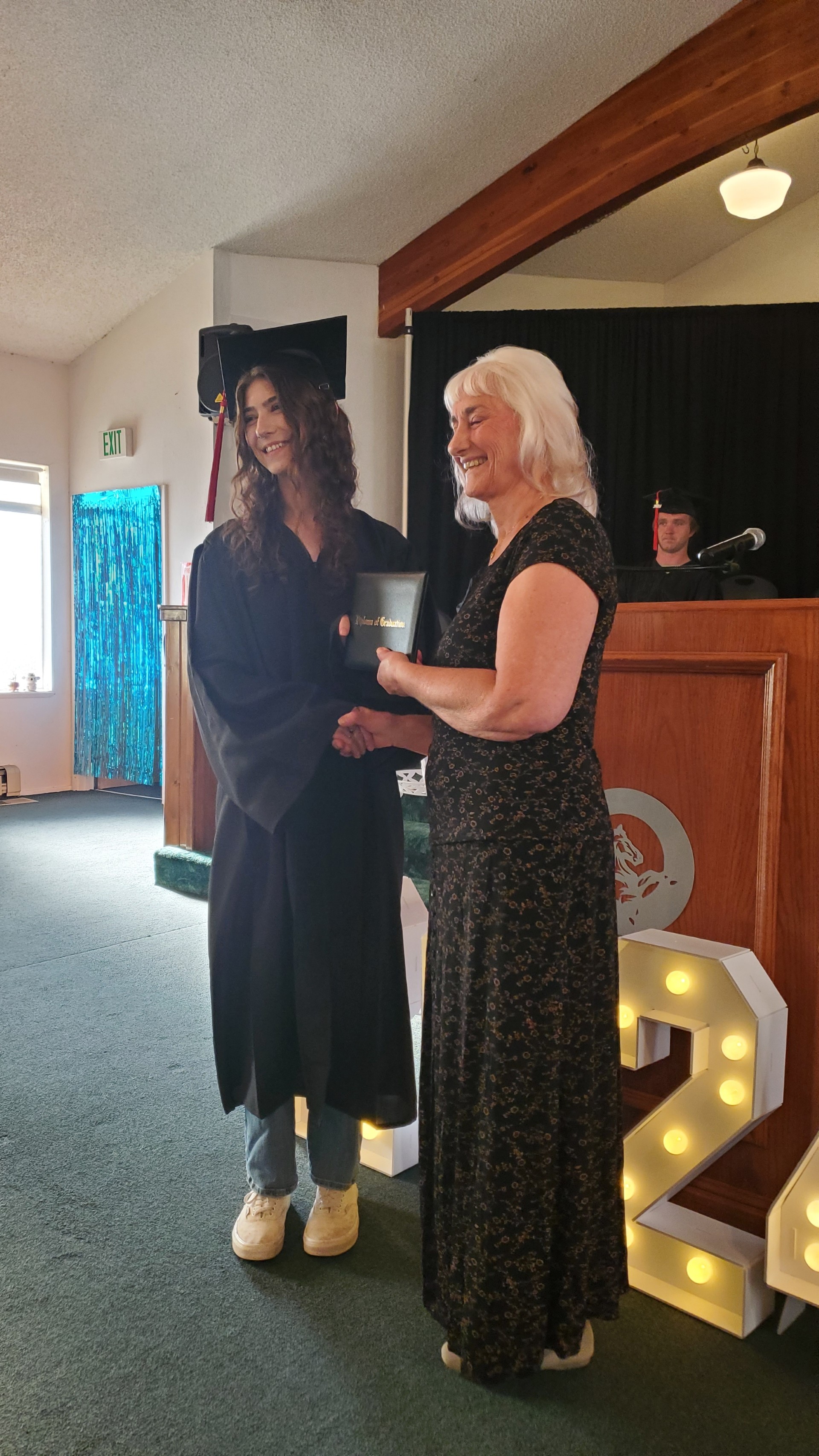 Ann Weaver congratulating Adult Education Graduate